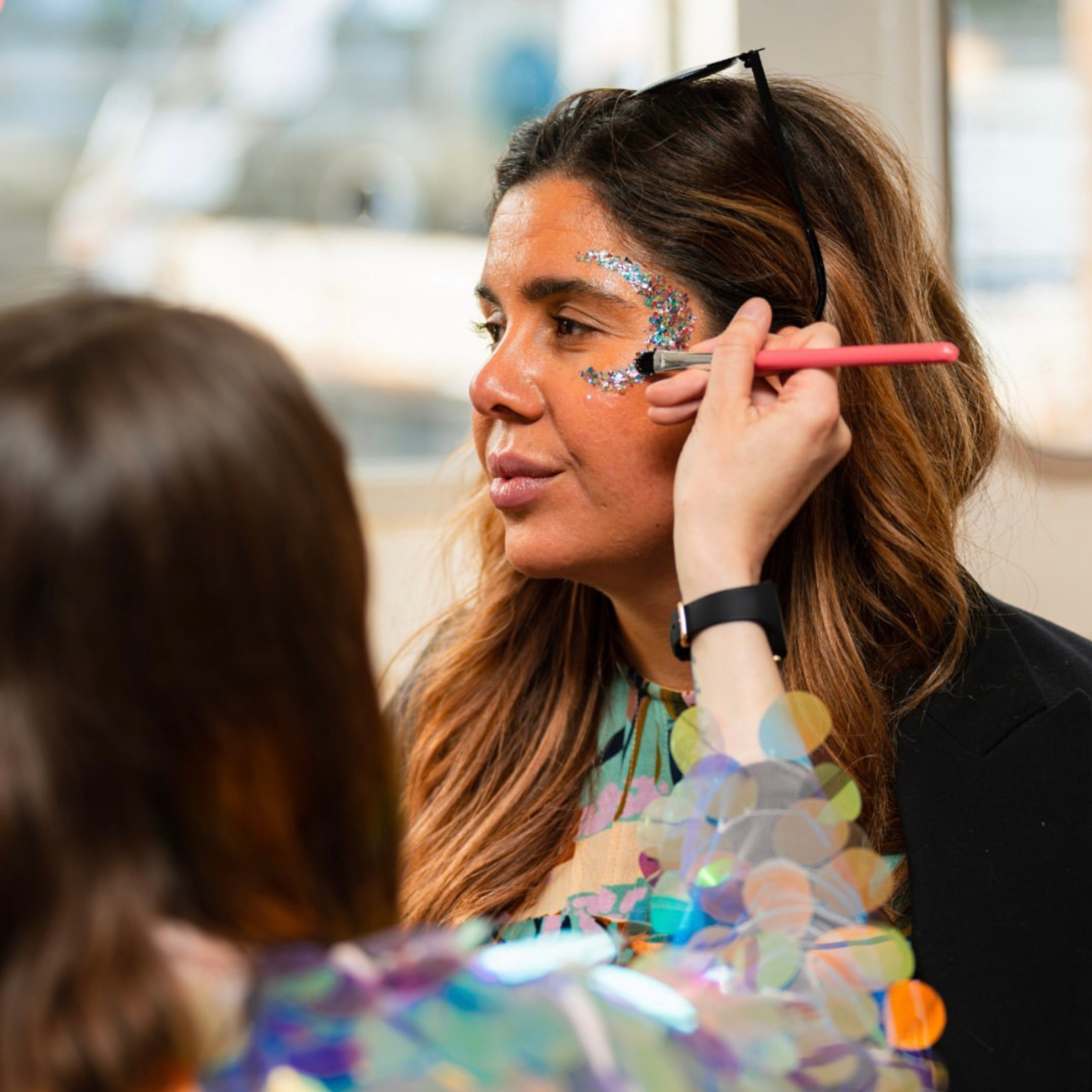 A glitter moon on the face of a client at a corporate event by Luminosity Glitter