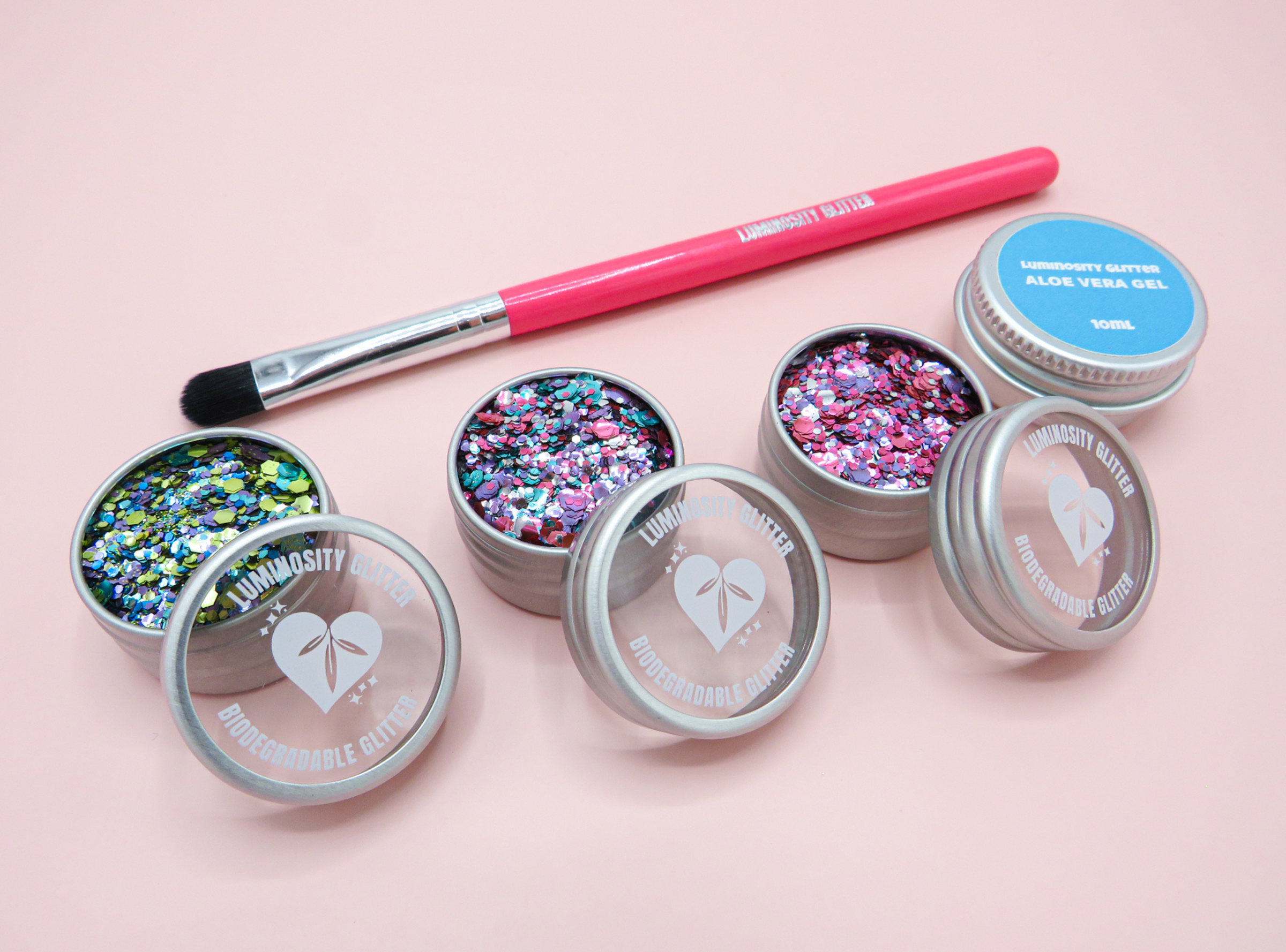 Razzmatazz Eco Glitter Set by Luminosity Glitter, including a trio of biodegradable glitters, an aloe vera application gel and hot pink makeup brush