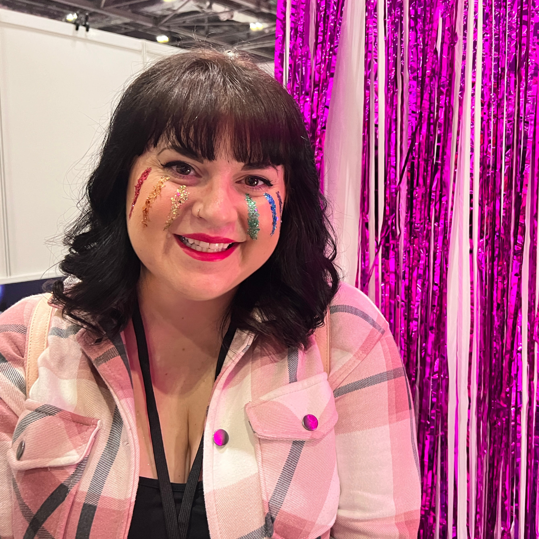 A female at Drag Con uk with glitter rainbow tears coming down her cheeks