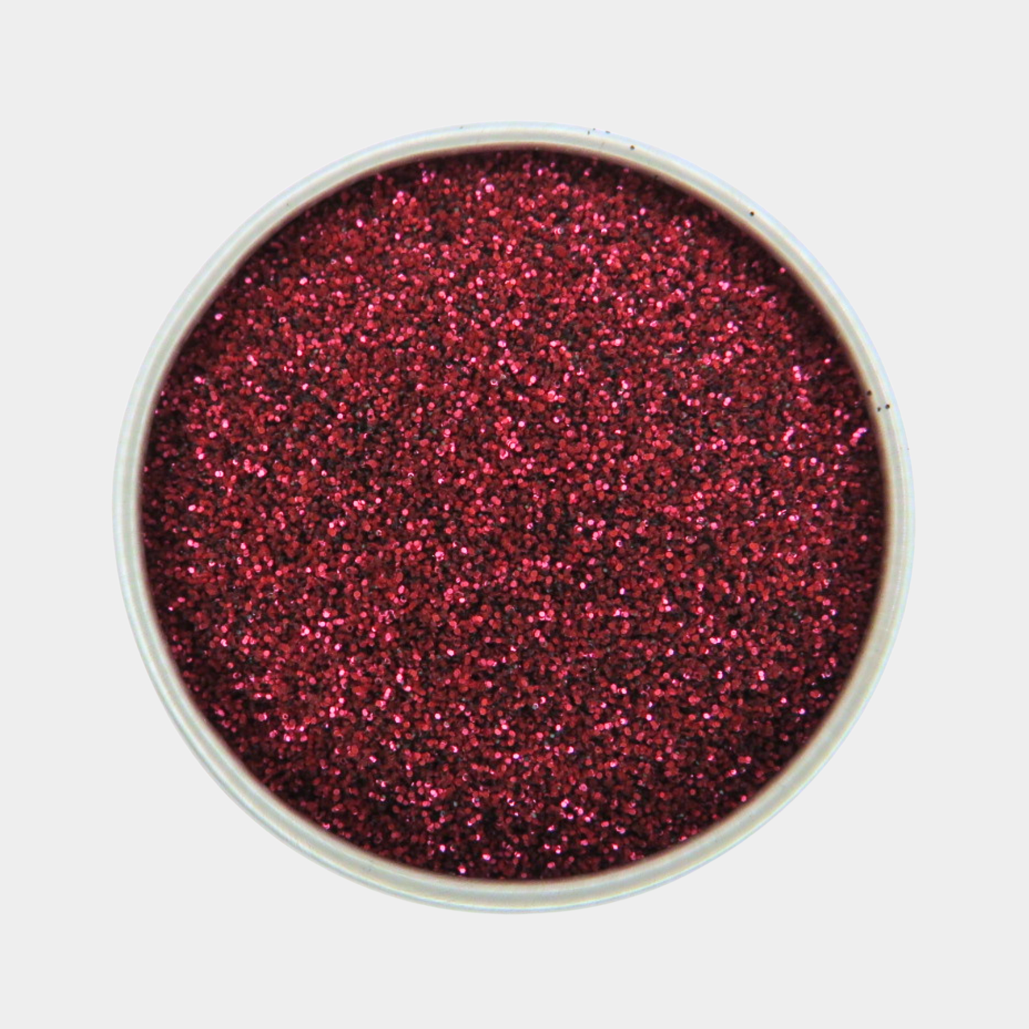 Red glitter in a small container on a white background