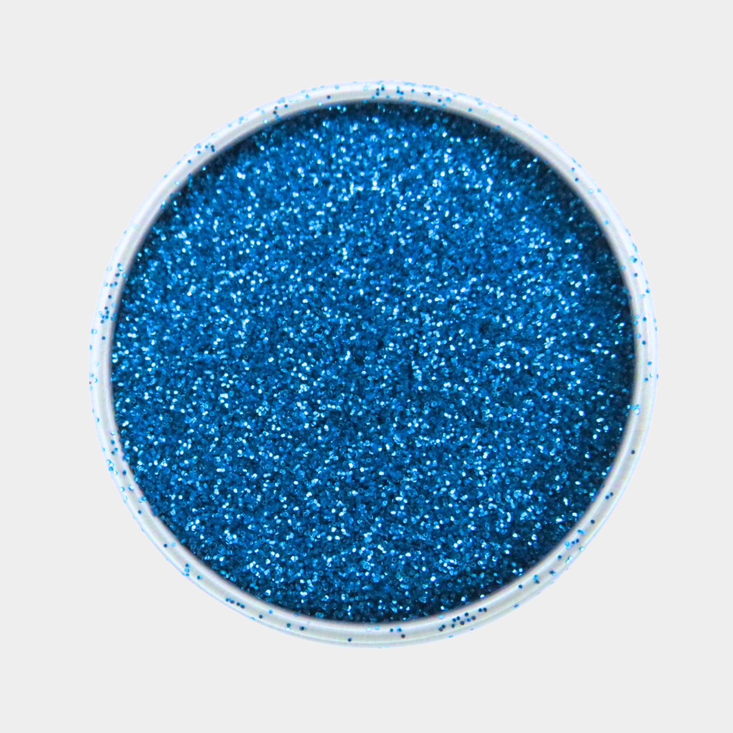 Blue glitter in a small round container on a light gray background