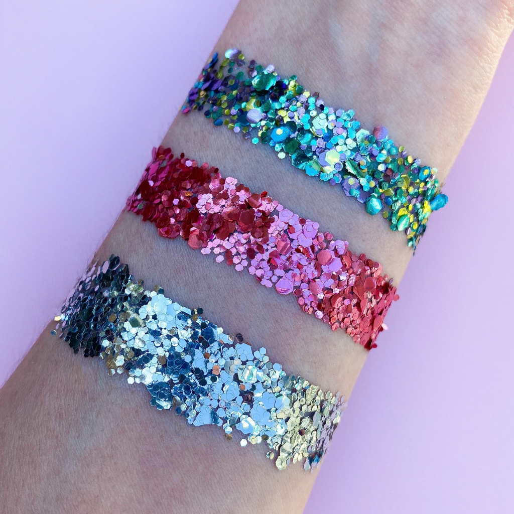 A glitter swatch on arm, peacock glitter blend, pink glitter blend and a silver glitter blend