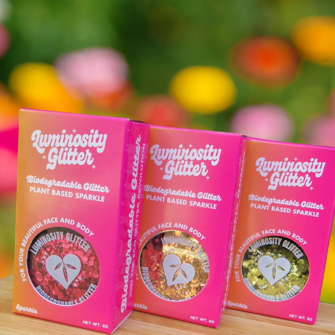 Luminosity Glitter's biodegradable glitter in pink and orange ombre packaging