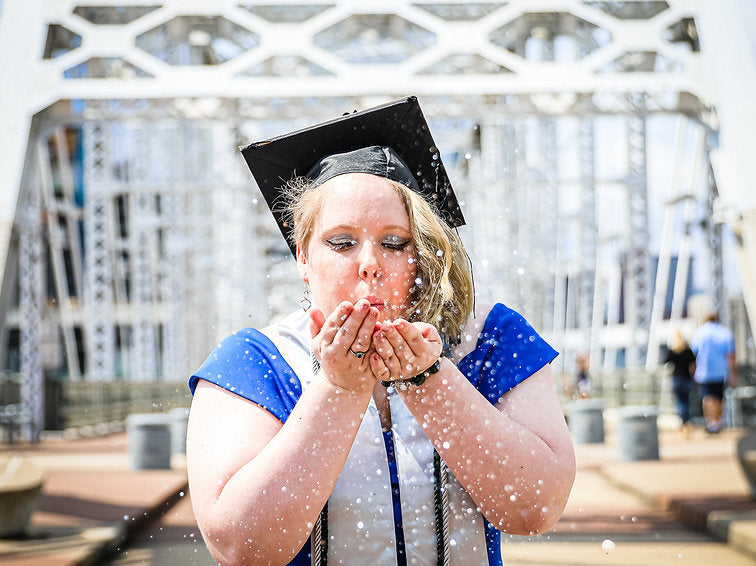 Blowing glitter at a graduation