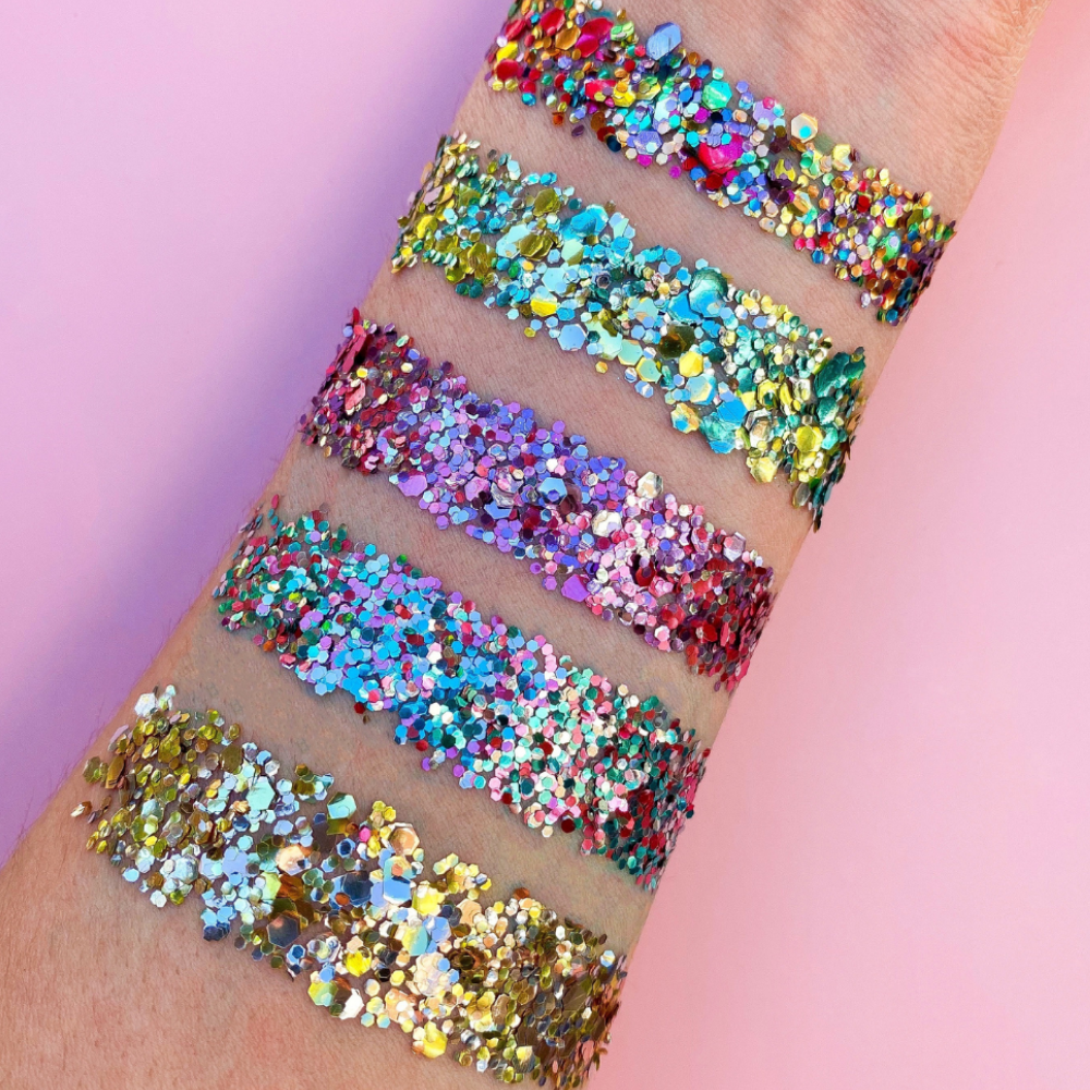 Arm swatch on a pink background of Luminosity Glitter's Festival Favourite glitters