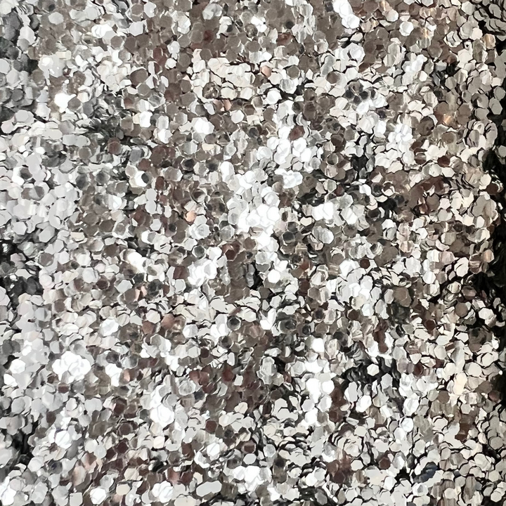 Close up of chunky silver biodegradable glitter by Luminosity glitter