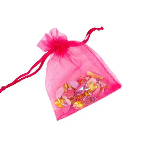 A hot pink organza bag filled with citrine face gems by Luminosity Glitter