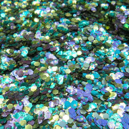 Close up of dragonfly eco glitter blend in green, gold and purple shades.