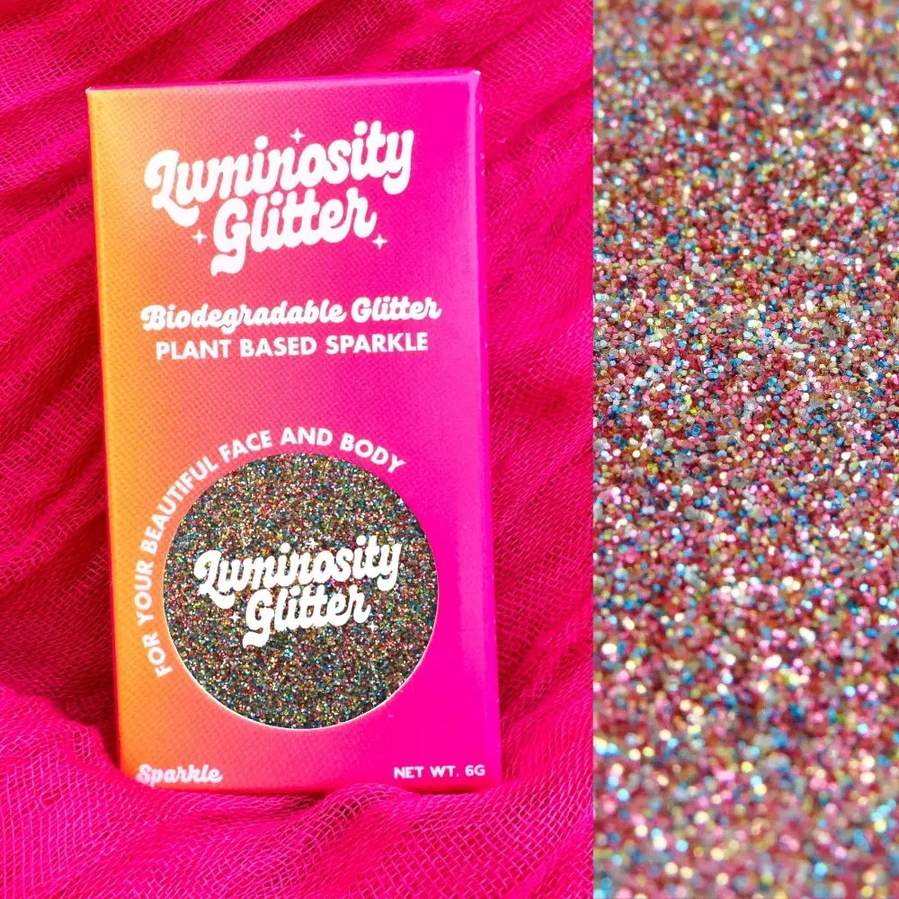 Fairy dust fine biodegradable glitter in a bright pink and orange ombre box for applying to your face, body, hair and nails.