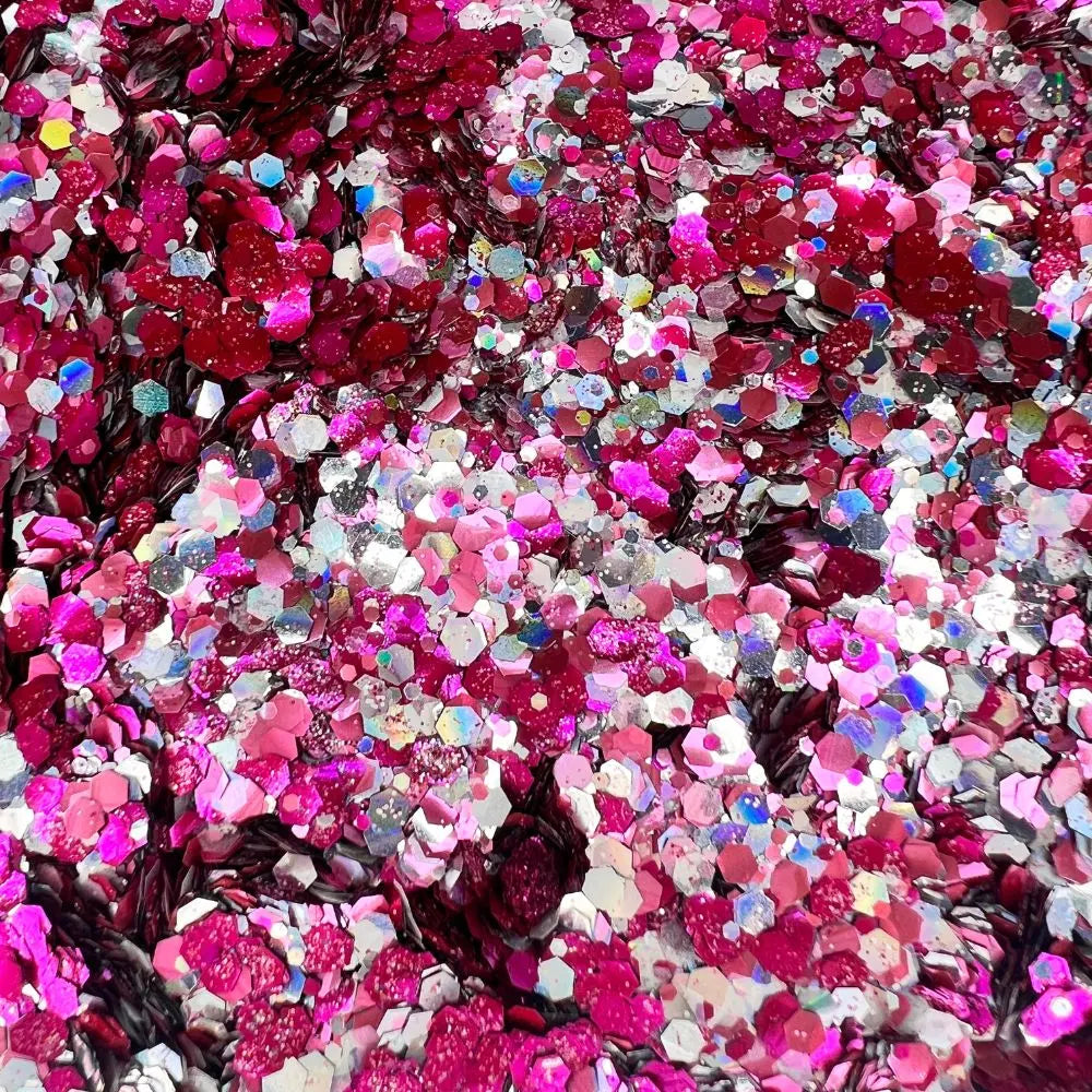 Close up of galactic blush bioglitter mix that is made up of rose pink, magenta, holographic silver and opal rose iridesecent shade of glitter.