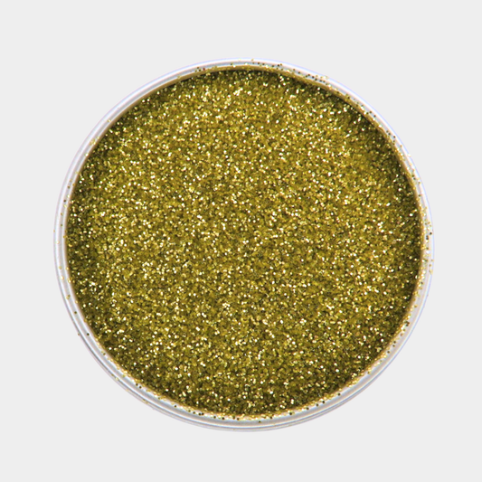 Gold glitter in a round container on a light gray background