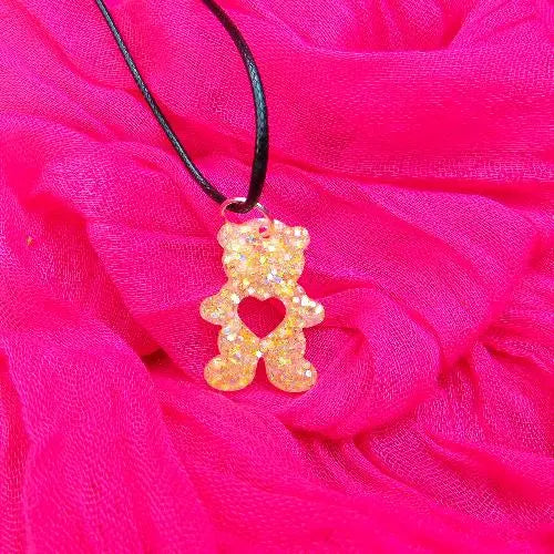 gold bear with a love heart belly necklace in a light gold glittery shade.