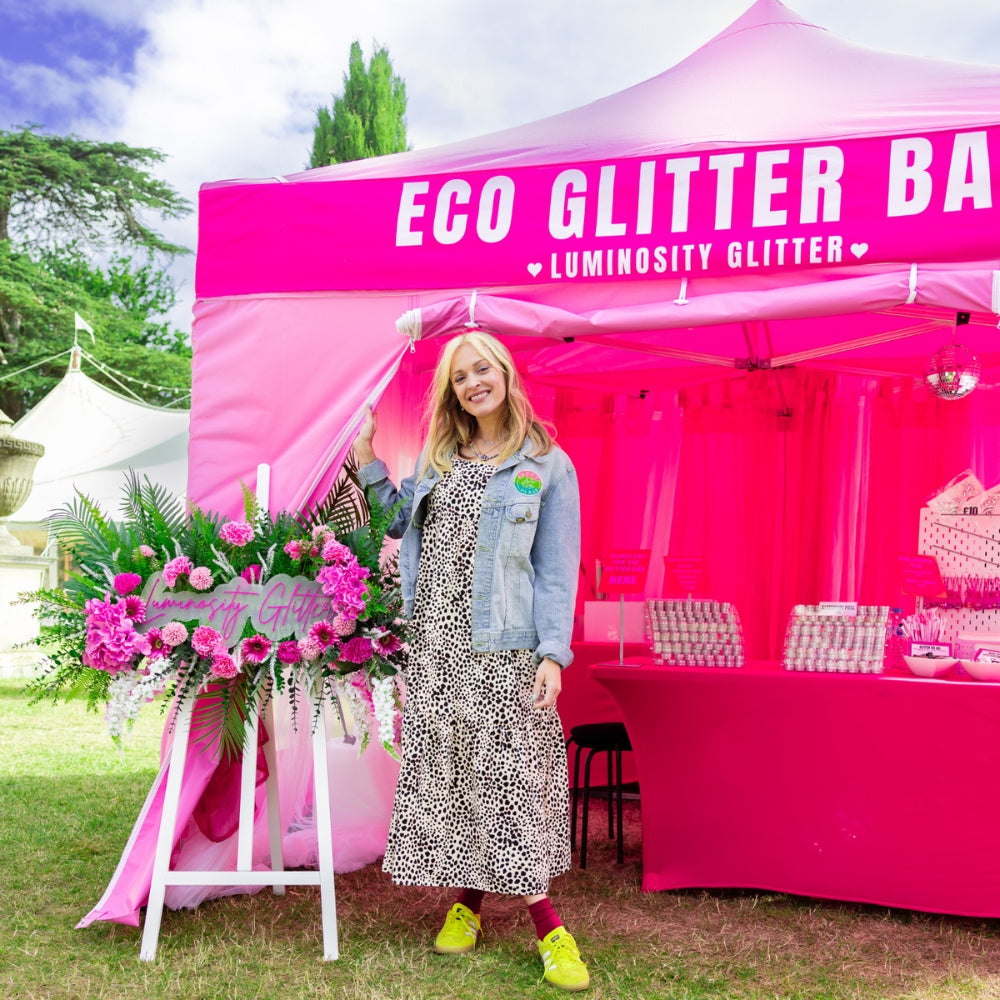 Happy Place Festival in Chiswick. Fearne Cotton standing outside Luminosity Glitter's bubblegum pink gazbeo and beautiful neon signage.