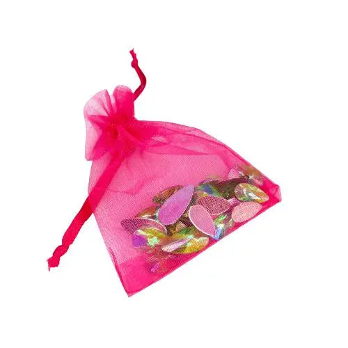 A hot pink organza bag filled with lime soda green reusable face gems for festivals and makeup by Luminosity Glitter