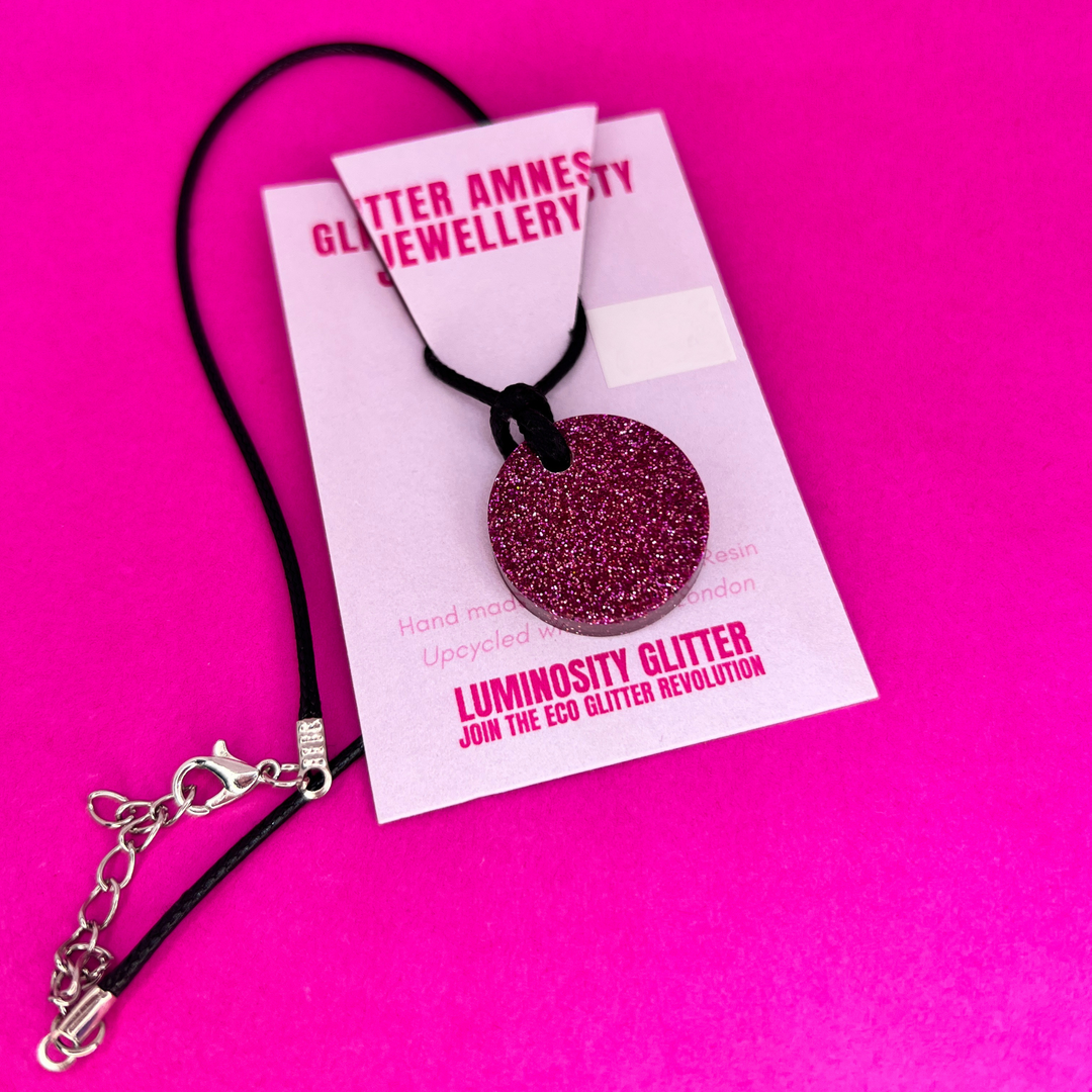 A round pink glittery necklace by Luminosity Glitter