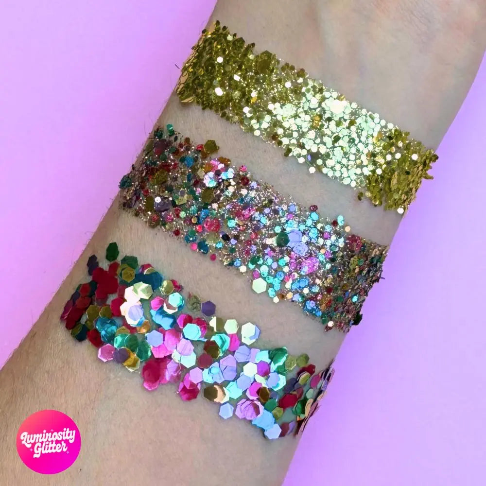 An eco glitter arm swatch of gold blend, rainbow smash blend and funfetti blend.