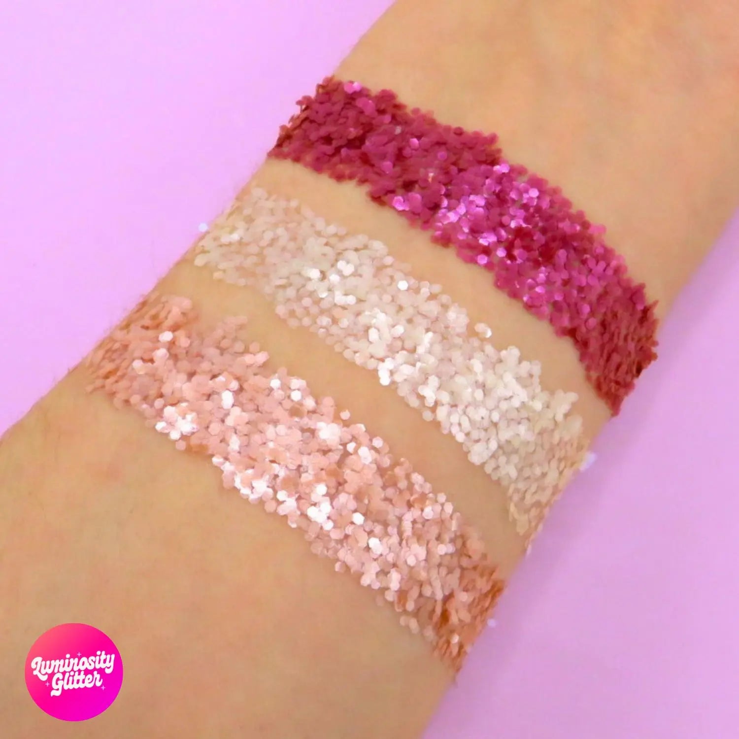 Rose all day eco glitter swatch on an arm of hot pink, light pink and clear soft shimmery glitter.