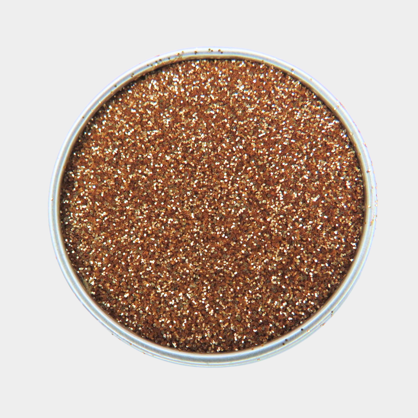 Metallic glittery powder in a round container on a light gray background
