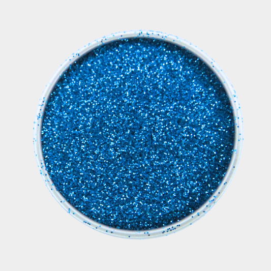 Blue glitter in a small round container on a light gray background