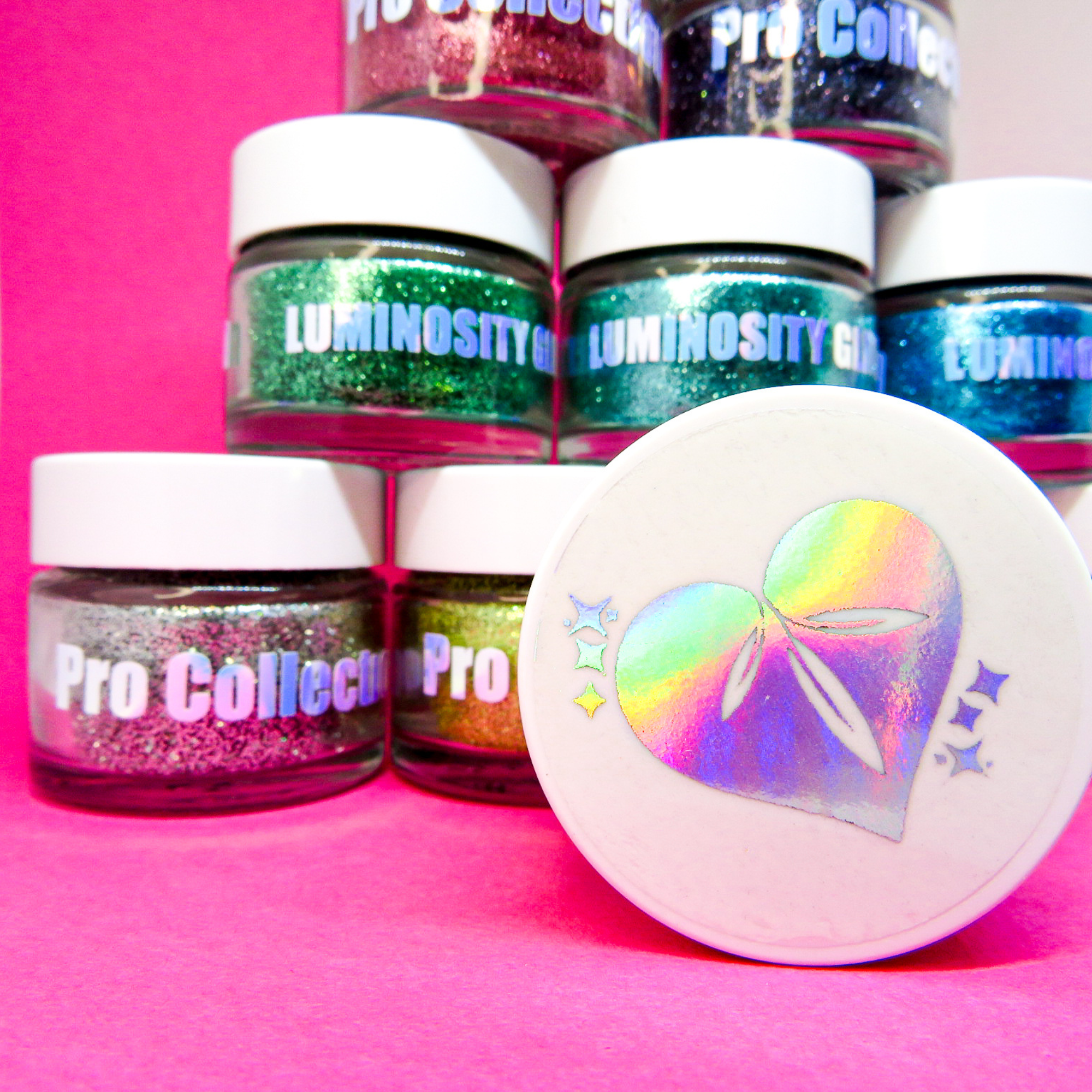Stardust biodegradable glitter range by Luminosity Glitter. The 15ml pots come with holographic silver stickers
