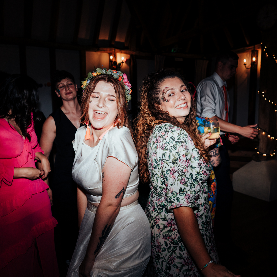 Dancing in face glitter at a wedding in Hampshire