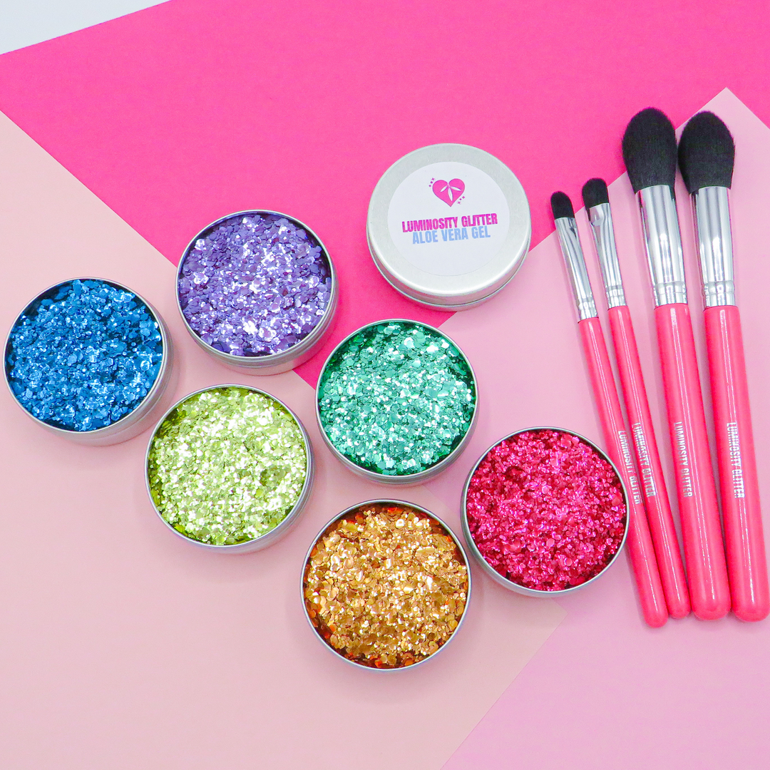 Rainbow Set of eco glitters in red, gold, orange, green, purple and blue. With a set of hot pink makeup brushes and aloe vera application gel.
