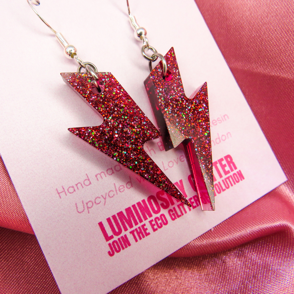 Glitter Amnesty earrings by Luminosity Glitter. Handmade in London using biobased resin. Lightning bolts on fish hook earring hooks.