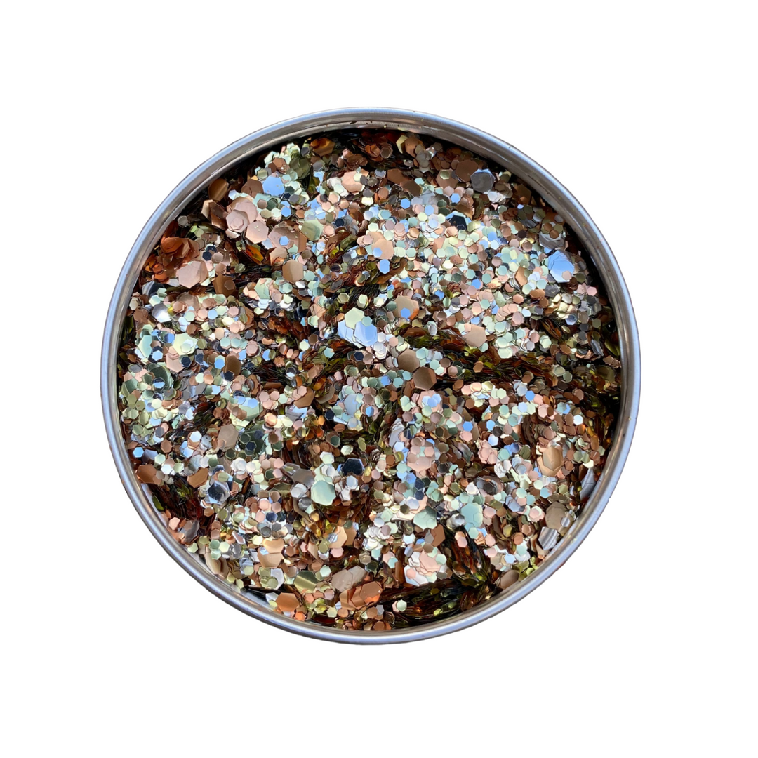 An aluminium pot filled with an orange, gold and silver eco glitter blend