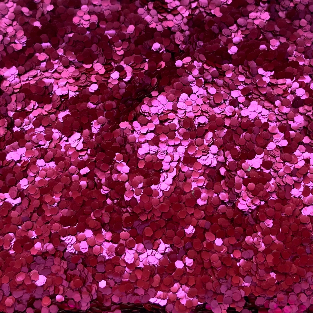 Chunky biodegradable glitter in a shade of magenta is good for creating a festival glitter eye look,.