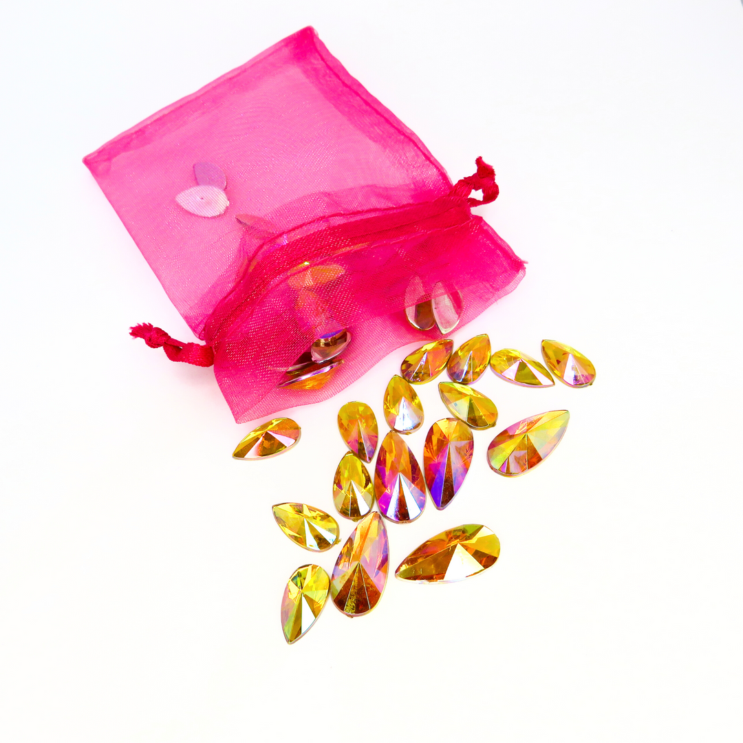 Citrine iridescent face gems in a shade of warm honey. These gems come in a hot pink organza bag to keep them safe after use.