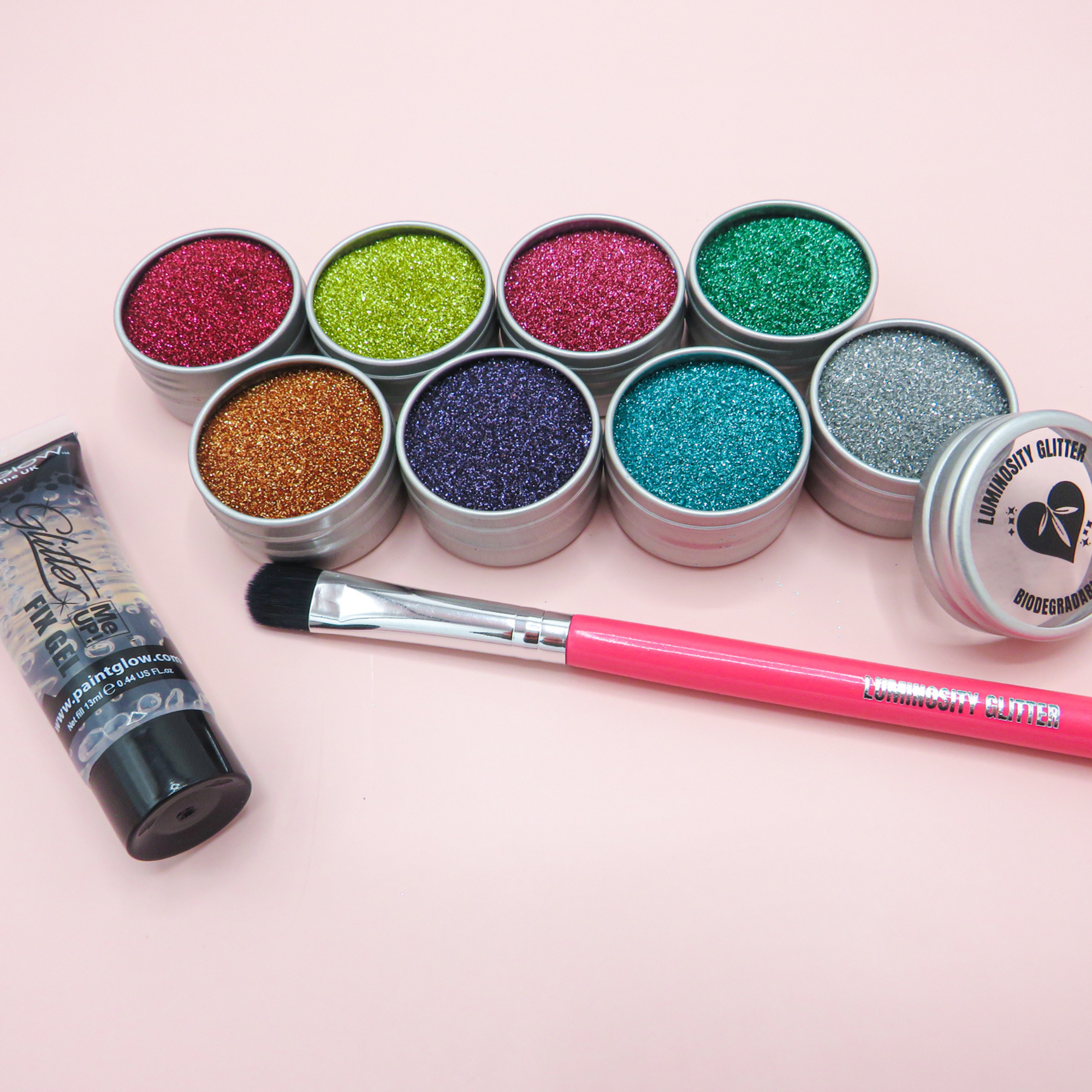 A fine set of eco glitters by luminosity glitter. Comes with a glitter fix gel and hot pink wooden makeup brush.
