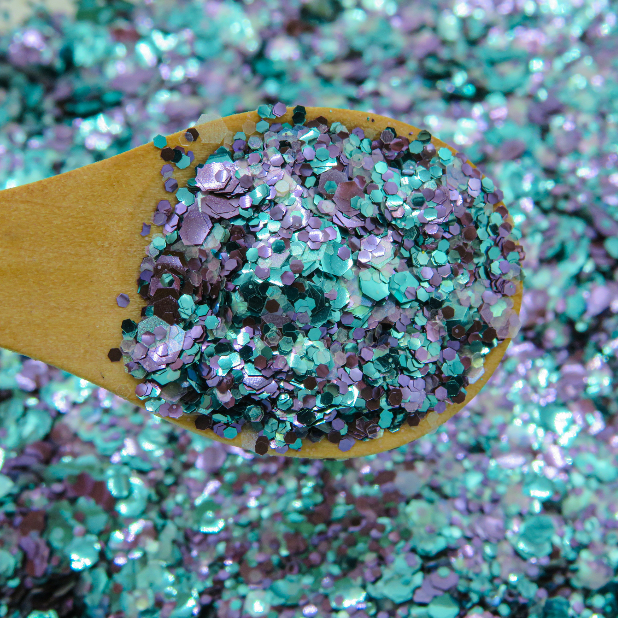 Purple and turquoise mix of eco glitters for cosmetics and makeup
