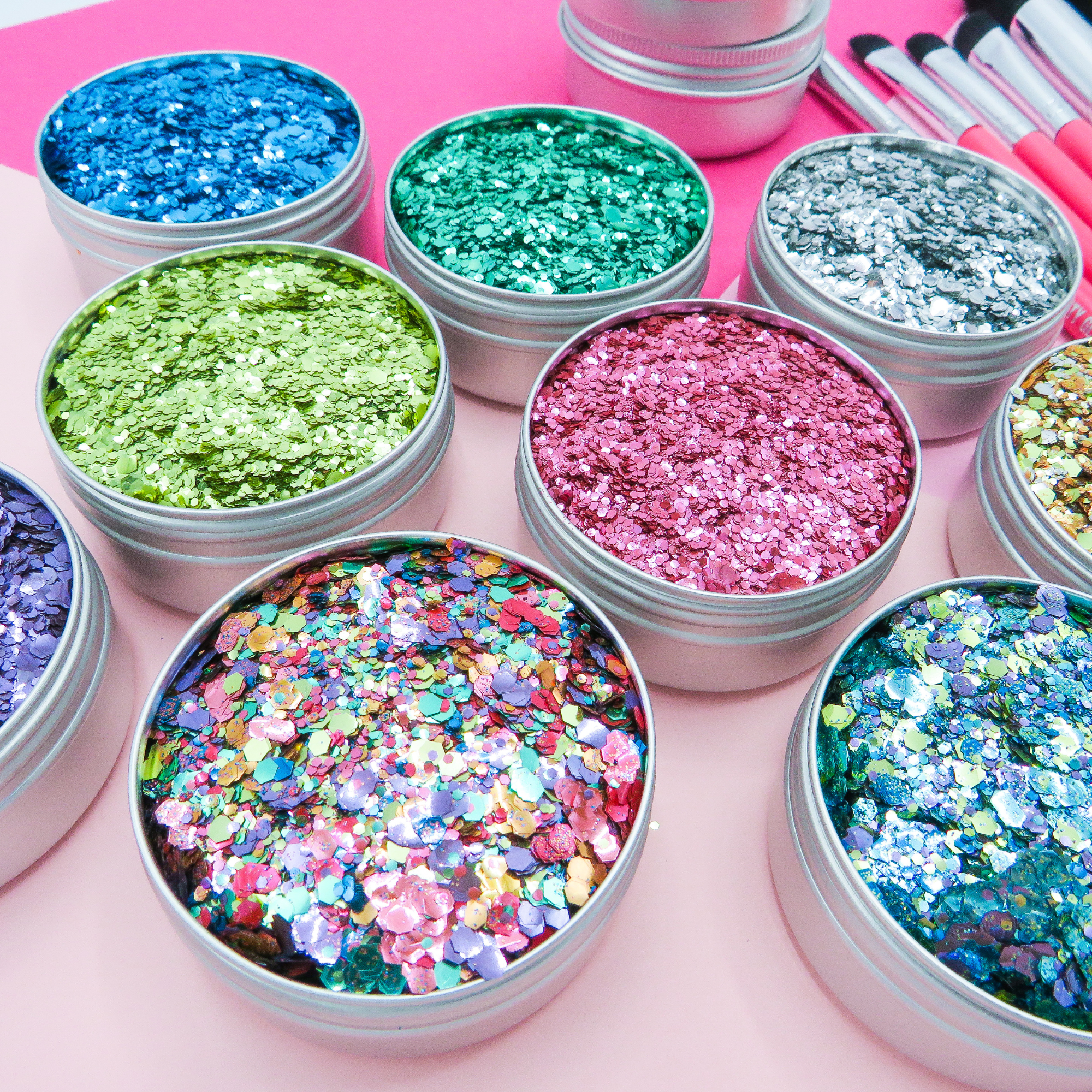Glitter artist' starter kit by Luminosity Glitter. Including 9 eco glitters, hot pink makeup brushes and aloe vera application gel.