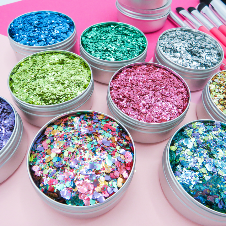 Glitter artist' starter kit by Luminosity Glitter. Including 9 eco glitters, hot pink makeup brushes and aloe vera application gel.