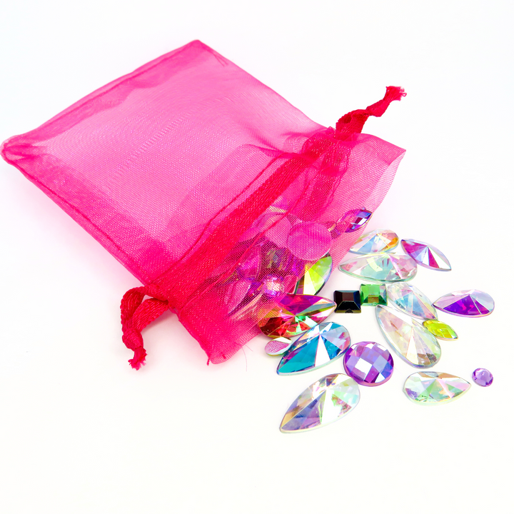 A hot pink organza bag filled with reusable face and body gems for festivals and makeup. Apply with a cosmetic fixative such as glitter glue or eyelash glue