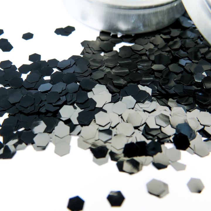 A close up of the ultra chunky hexagonal glitter flakes in obsidian black by Luminosity Glitter