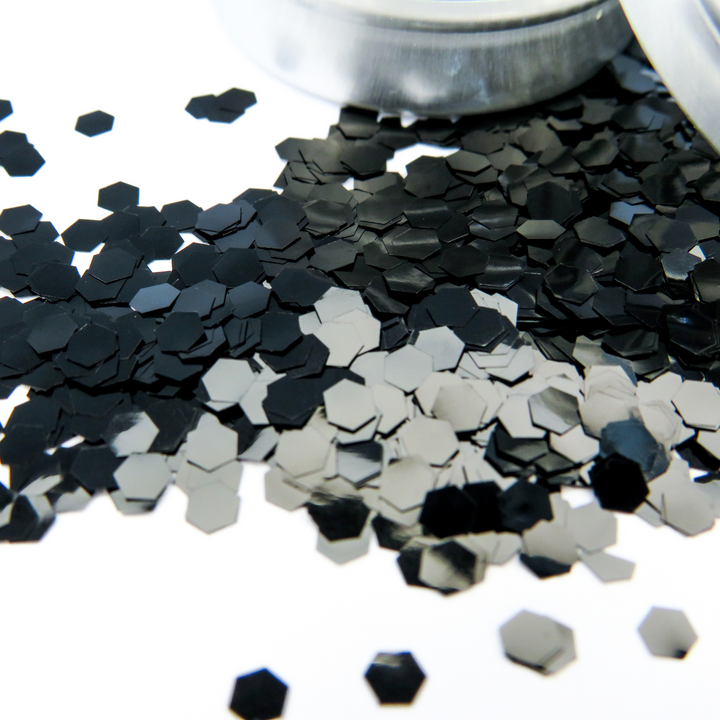 A close up of the super chunky hexagonal glitter flakes in obsidian black by Luminosity Glitter