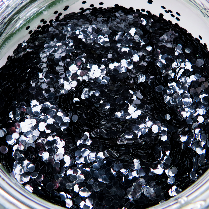 Obsidian black biodegradable glitter in hexagonal shape. Suitable for face, body, hair and nails