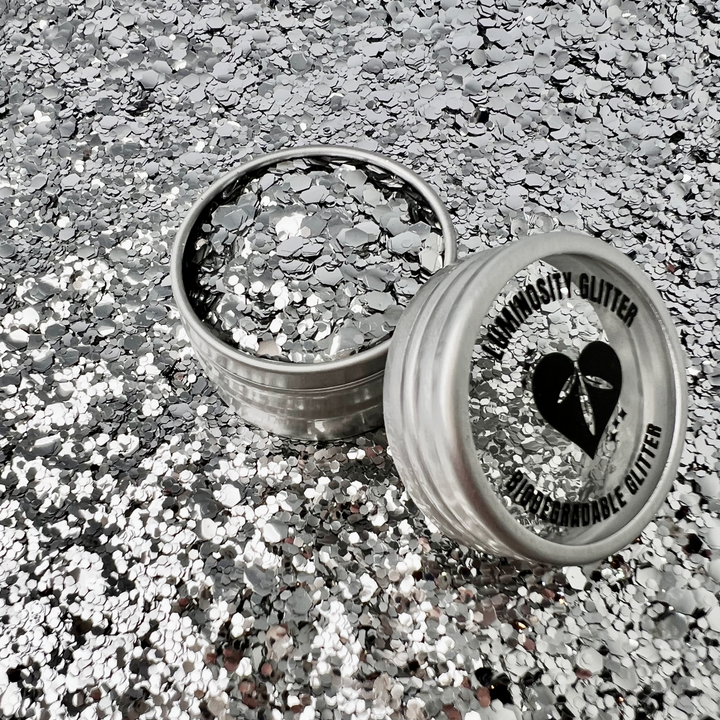 A glittery mix of silver eco friendly glitter in an aluminium pot with a window lid.