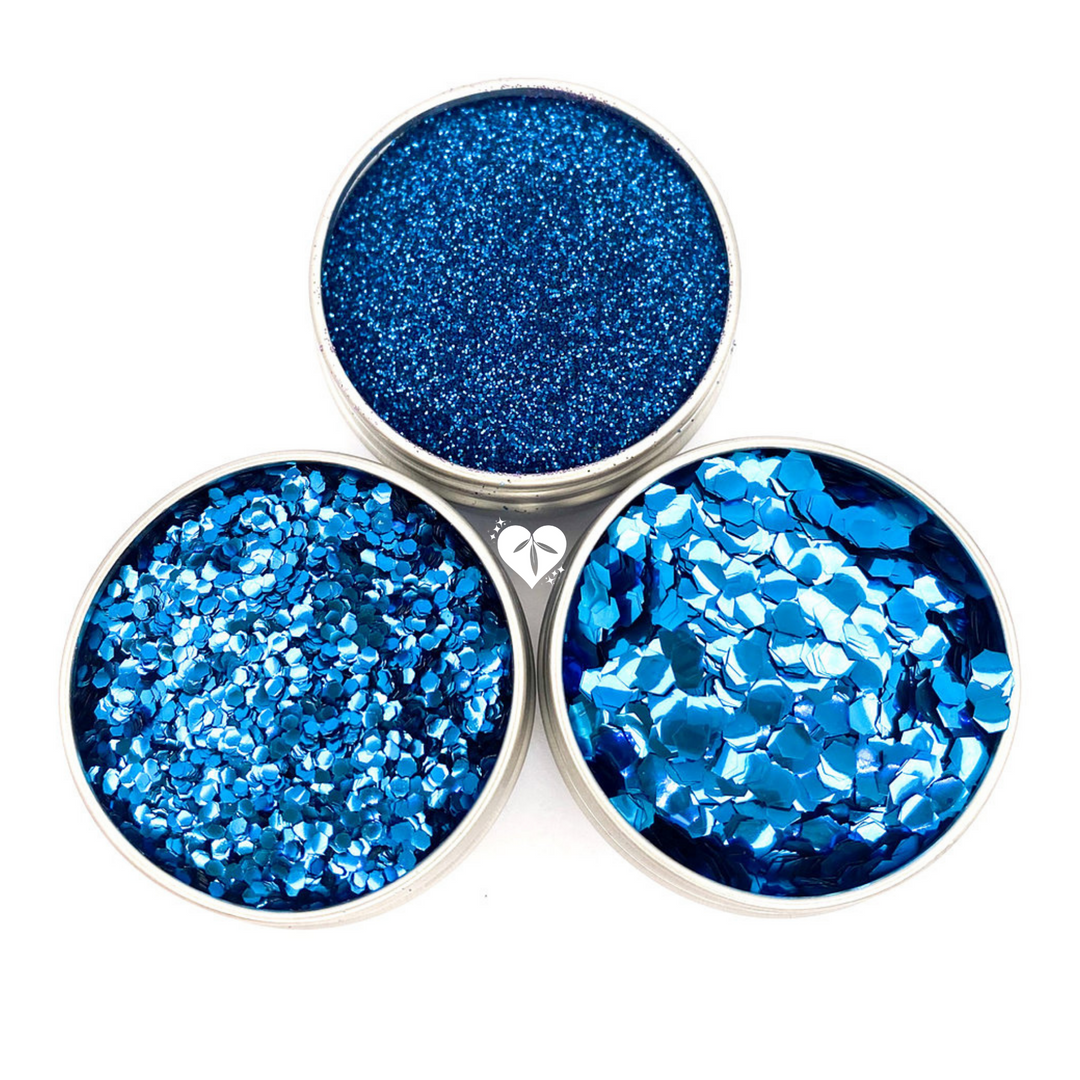 trio of blue biodegradable glitters in aluminium pots for makeup looks and festival glitter body art.